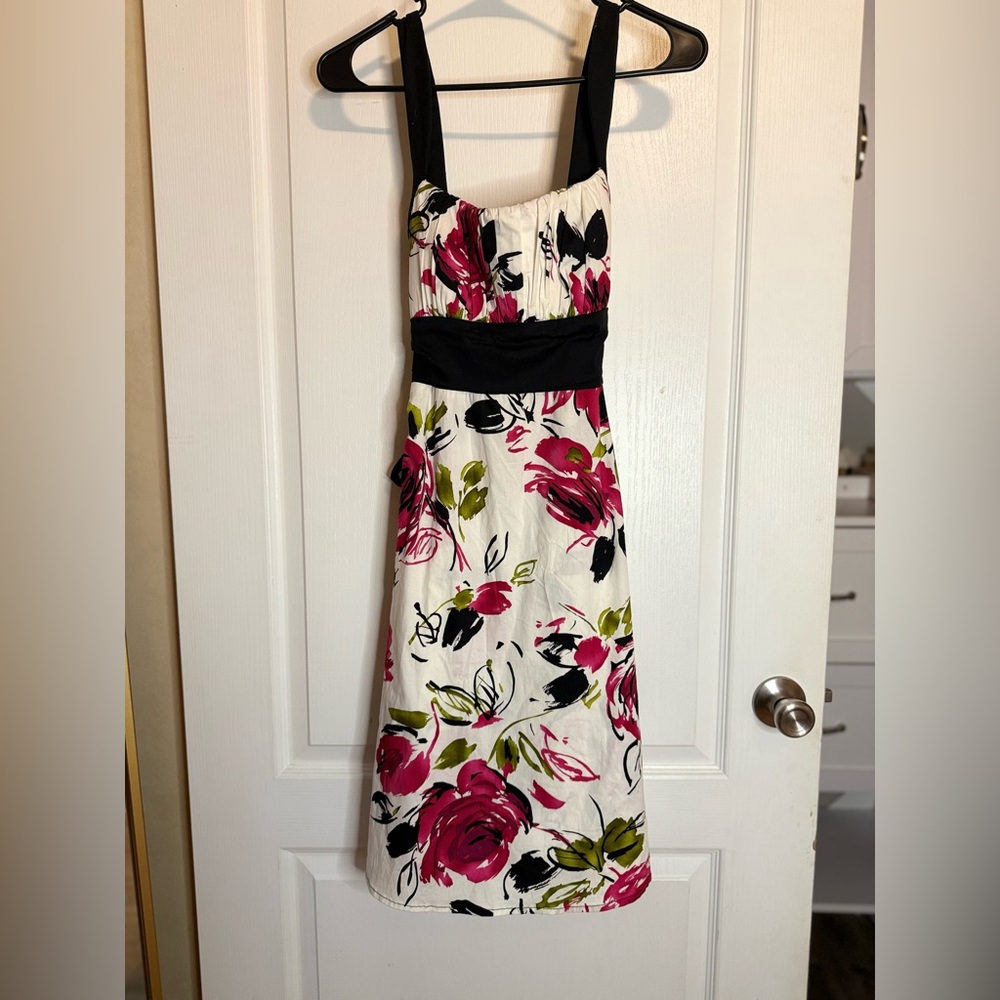 B. Smart White Dress with Red and Black Floral Design
